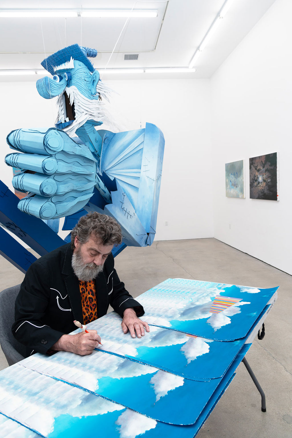 Photo of artist Wayne White signing his print HumanFuckinKnowledge at Hashimoto Contemporary Los Angeles