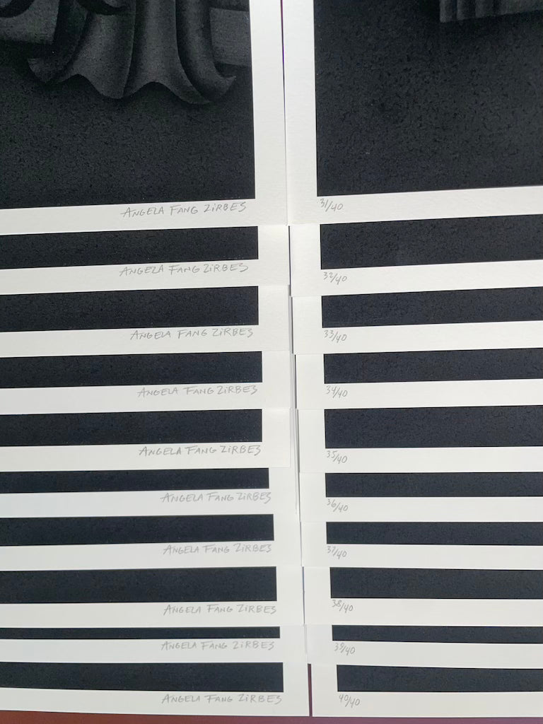 stacked black prints with artist signature 'Angela Fang Zirbes' and edition numbers visible