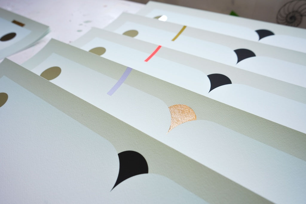 print by Madeleine Tonzi of a landscape in neutral greens, blues, and pinks with gold leaf embellishments