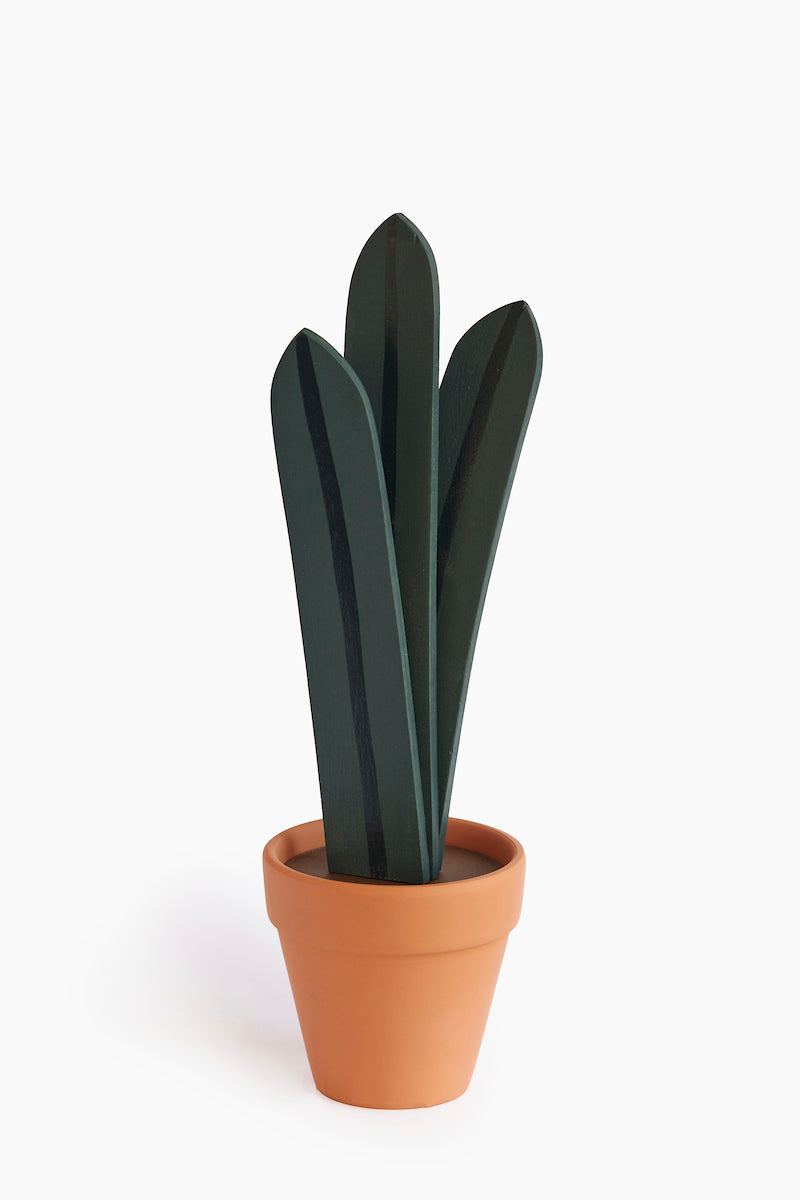 Wooden sculpture of a tall plant with three long leafs in a terracotta pot