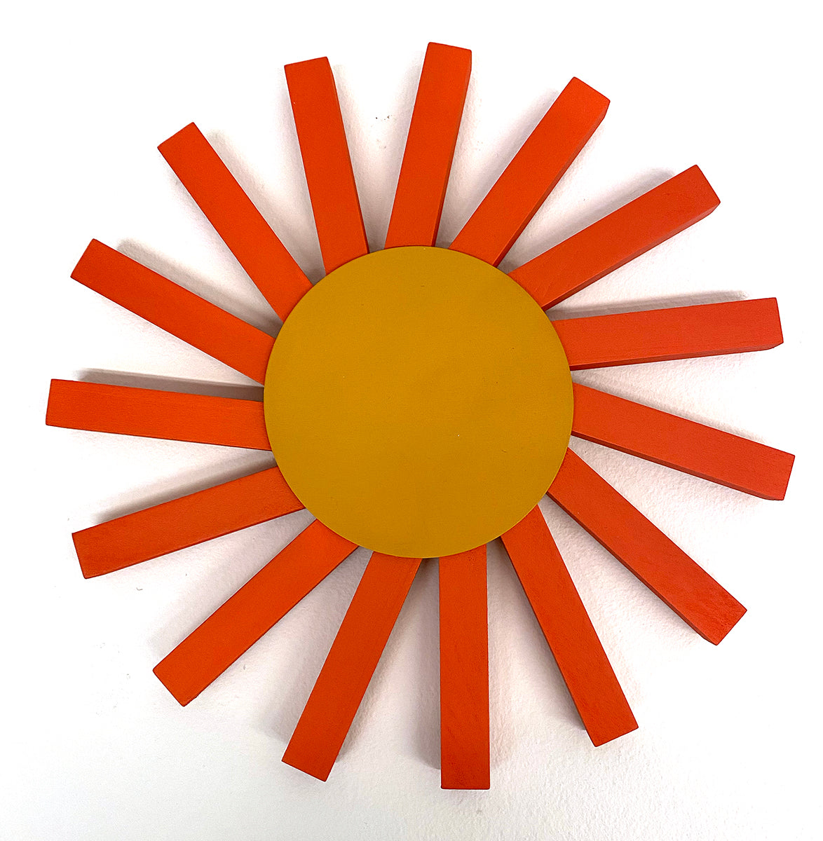 wooden sculpture of a sun