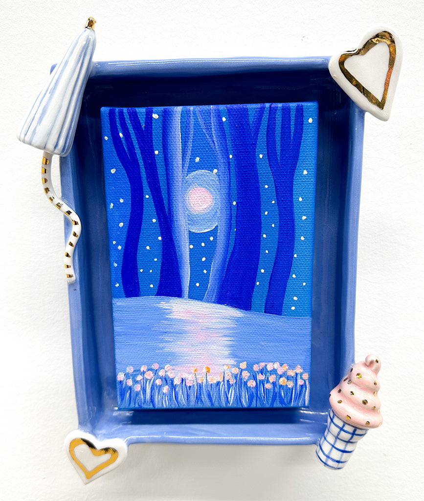 Photograph of a ceramic frame with abstract gilded ceramic elements and a small painted canvas in the center by Jen Dwyer