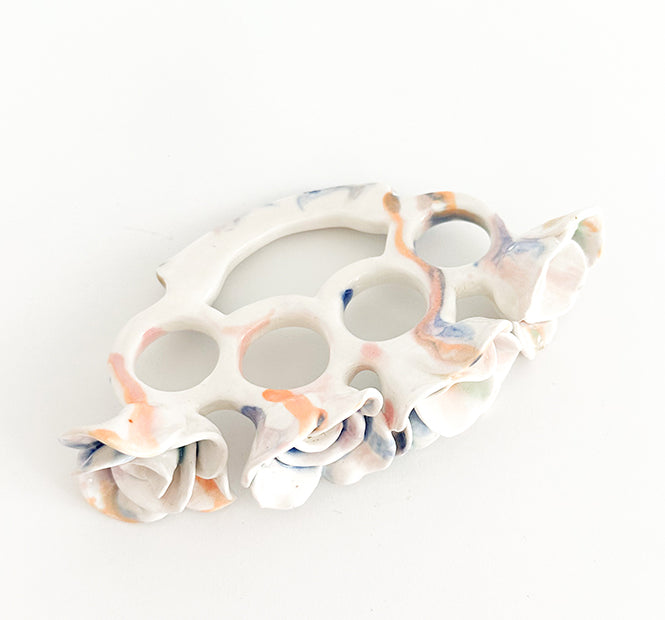 Photograph of a ceramic knuckle piece with multicolor roses by Jen Dwyer.