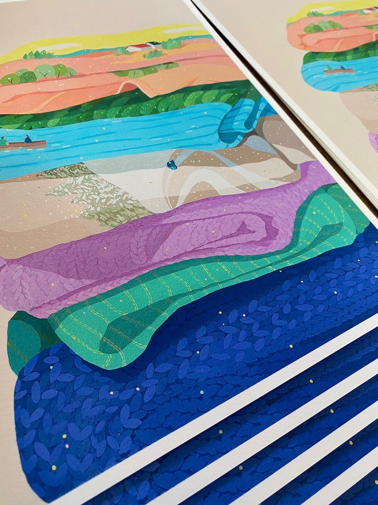 Danym Kwon print of quilts with landscapes depicted on them, pastel colors, fanned across surface