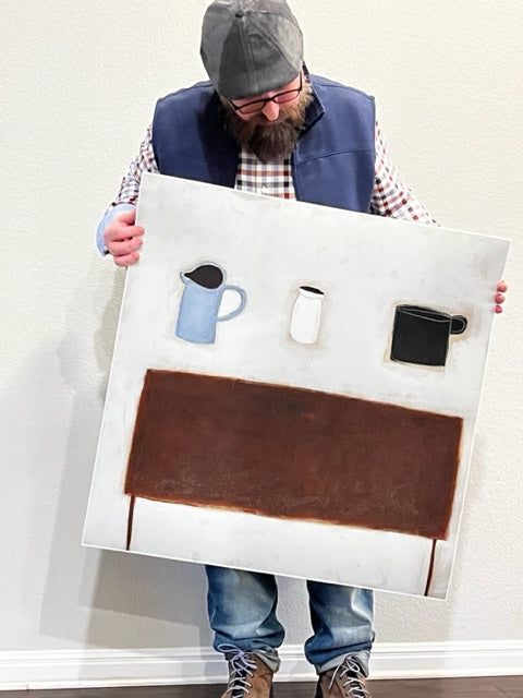 Photograph of artist Gabe Langholtz holding a copy of his print, Lightness