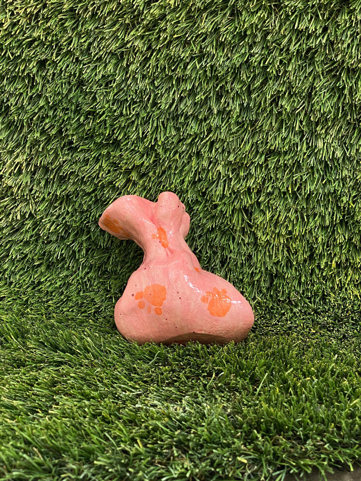Ceramic sculpture of dog poop bag in pink