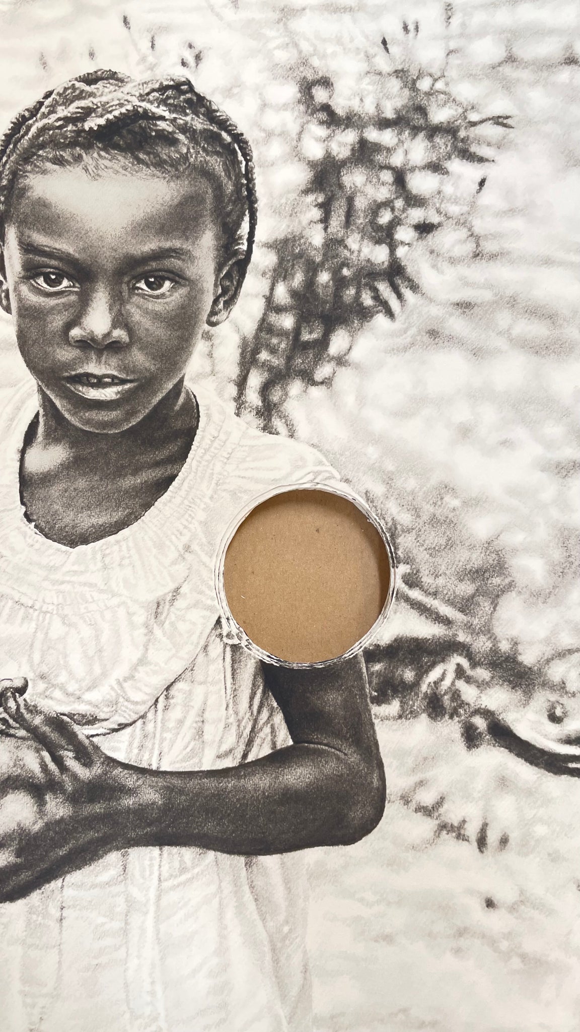 a close up photo of the young girl and the hole cut out of the print 